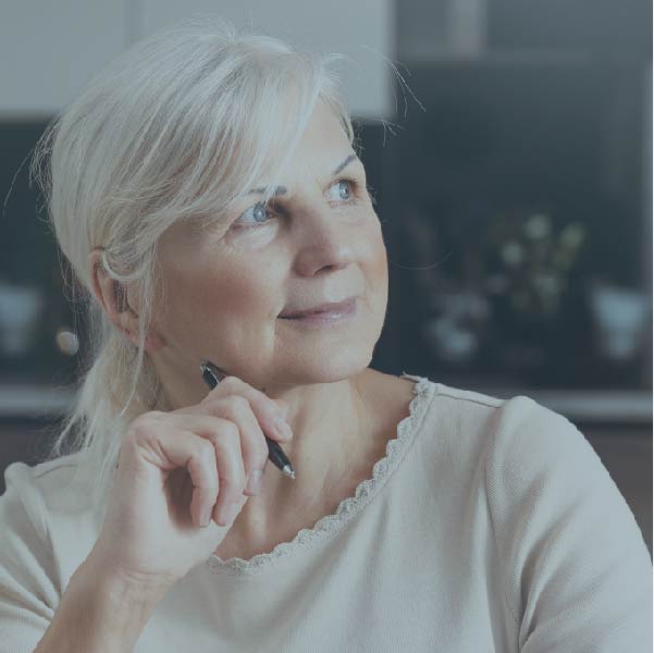 Elderly woman staring off into the distance.